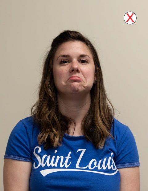 A headshot of a woman wearing a SLU t-shirt. She is frowning deeply at the camera.