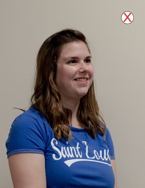  headshot of a woman wearing a SLU t-shirt. Her head and body are angled to the right and away from the camera. 