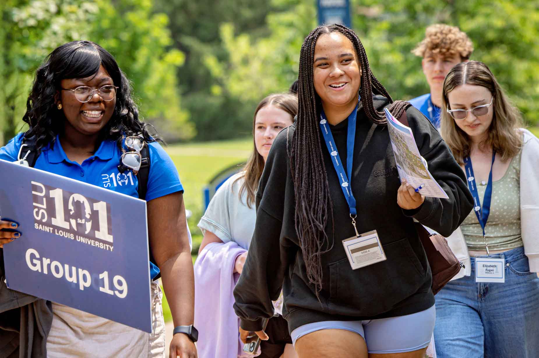 A student leader walking students through campus as part of SLU101