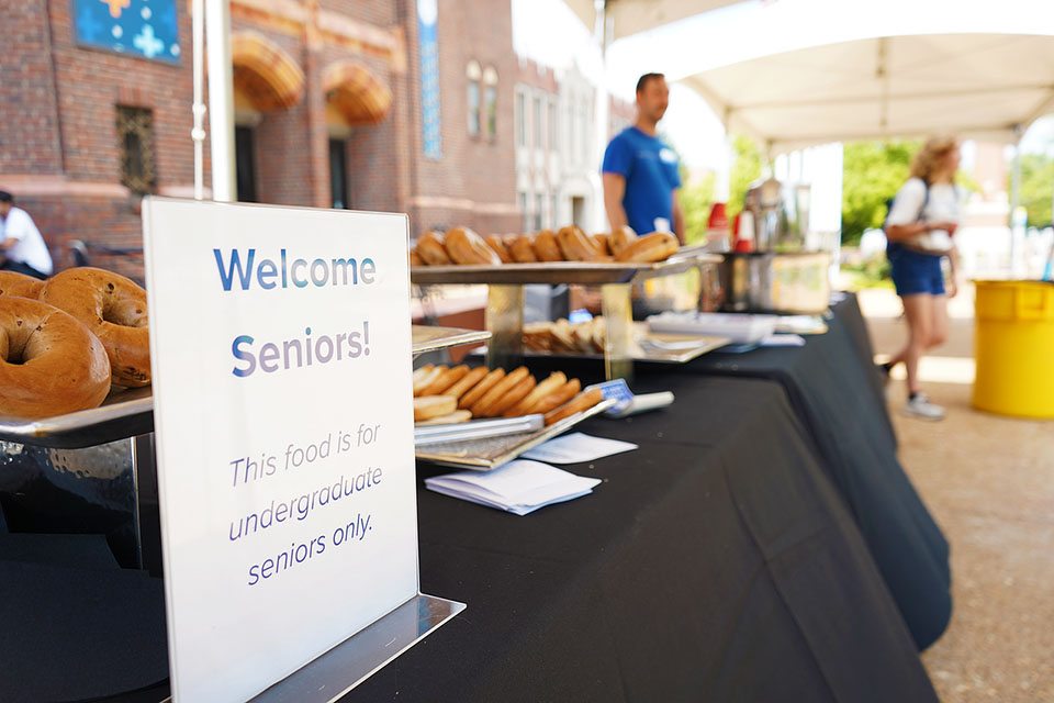A table is filled with bagels and coffee for seniors on their last first day of school.