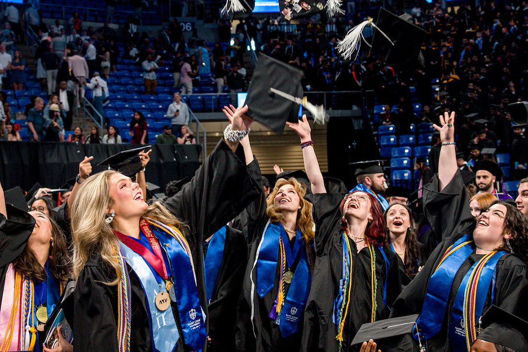 VPA Class of 2025 A group of women throw their graduation caps