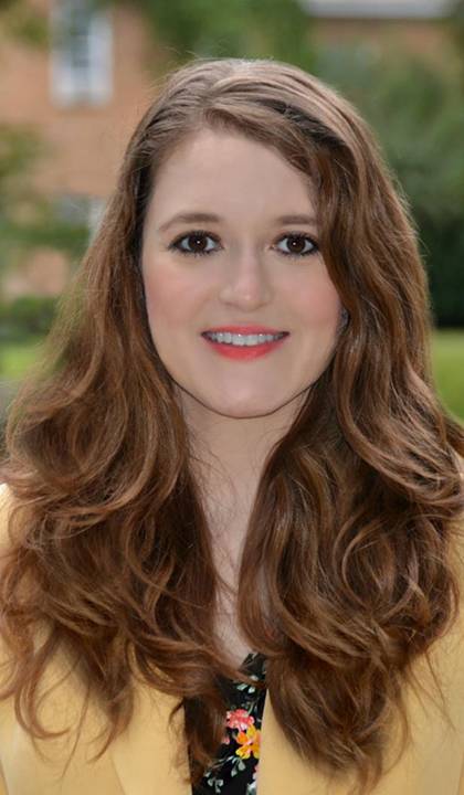 a woman smiles for a portrait