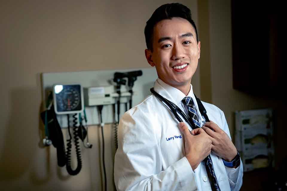 Larry Yang A medical student poses for a photo in a doctor's office simulation lab.