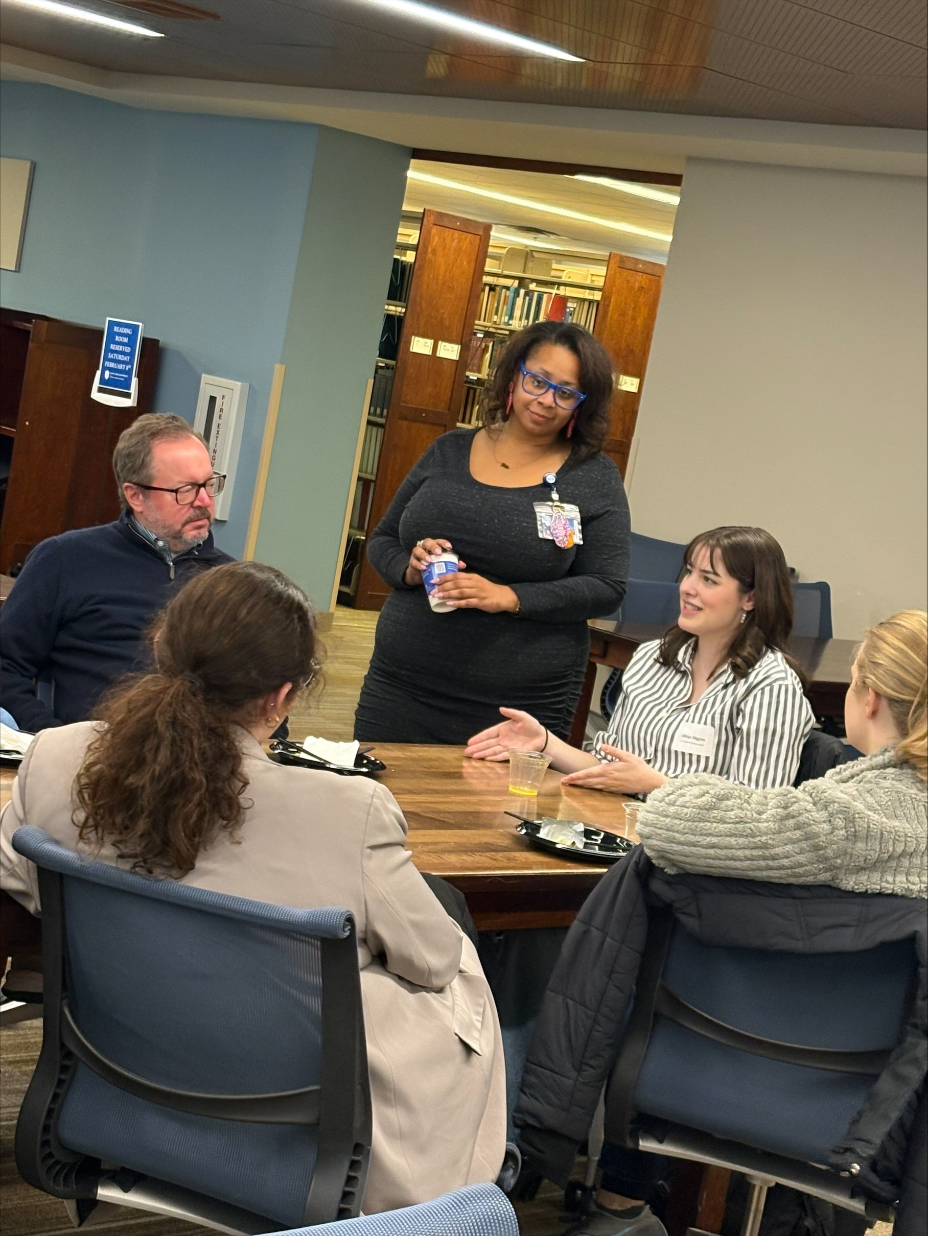dean belinda dantley greats a table of students in Scott Hall