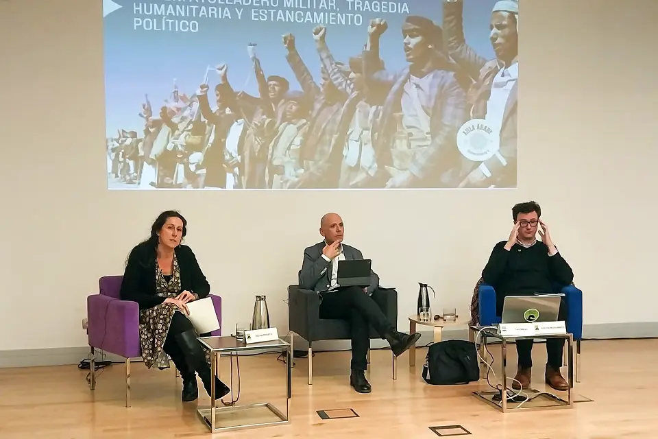 Three people speaking during a conference