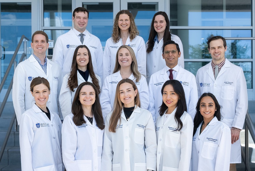 A group photo of the Dermatology residents posing on a set of exterior stairs.
