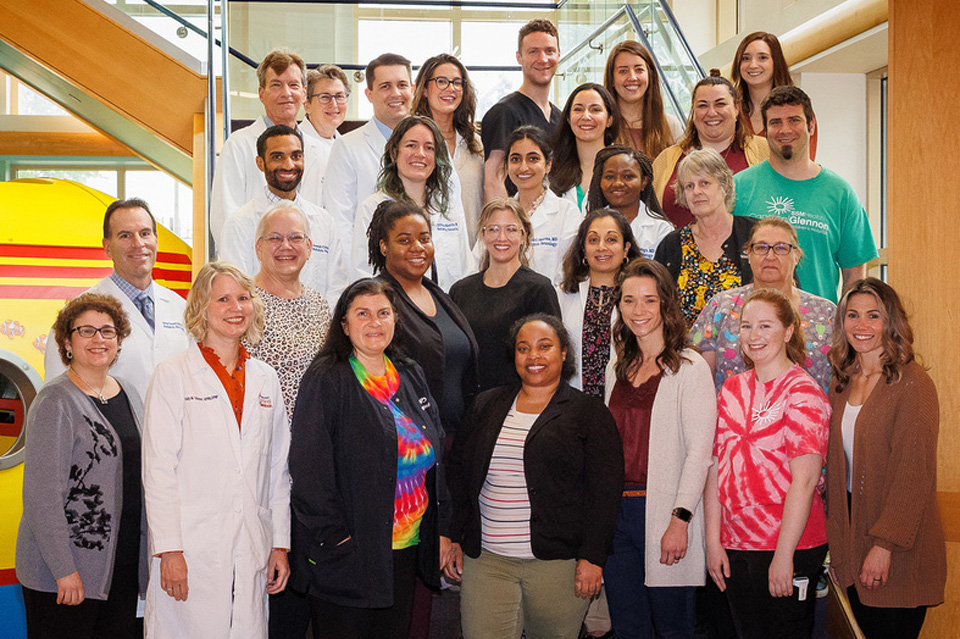 Photo of entire Child Neuro Group Group photo of entire Child Neuro Group standing in front of staircase.