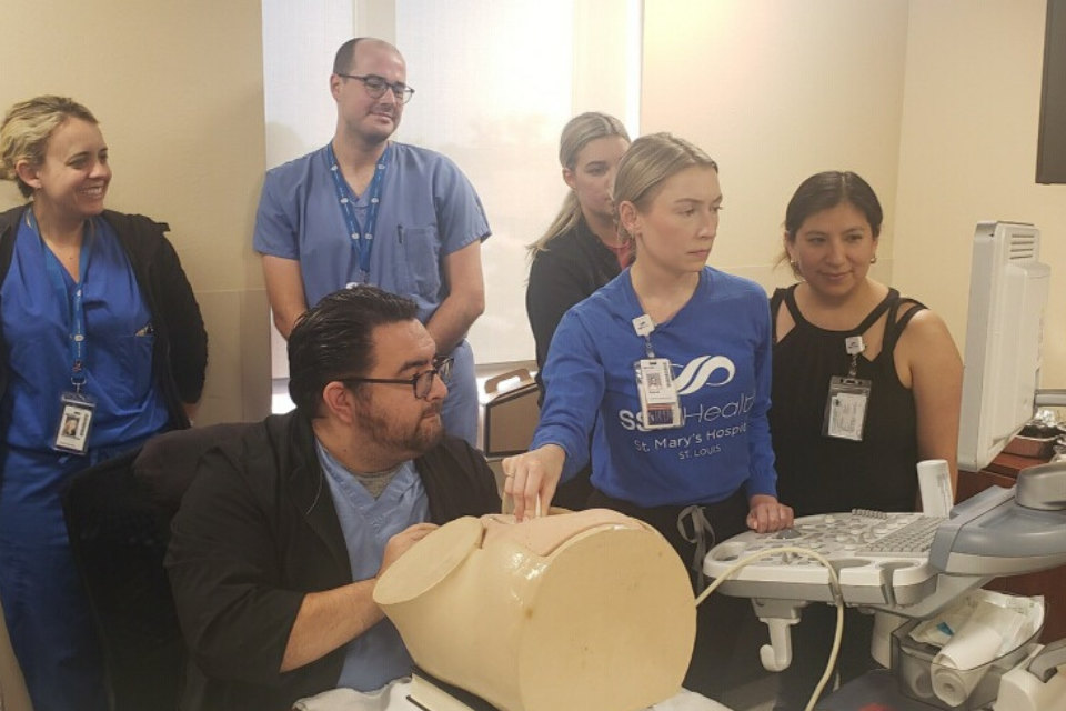 Maternal-fetal medicine fellows work in a sim lab, performing an ultrasound