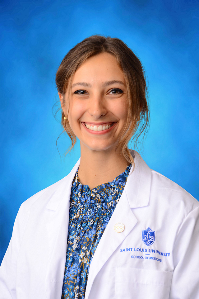Page Colbert Paige Colbert poses for a headshot against a blue background.